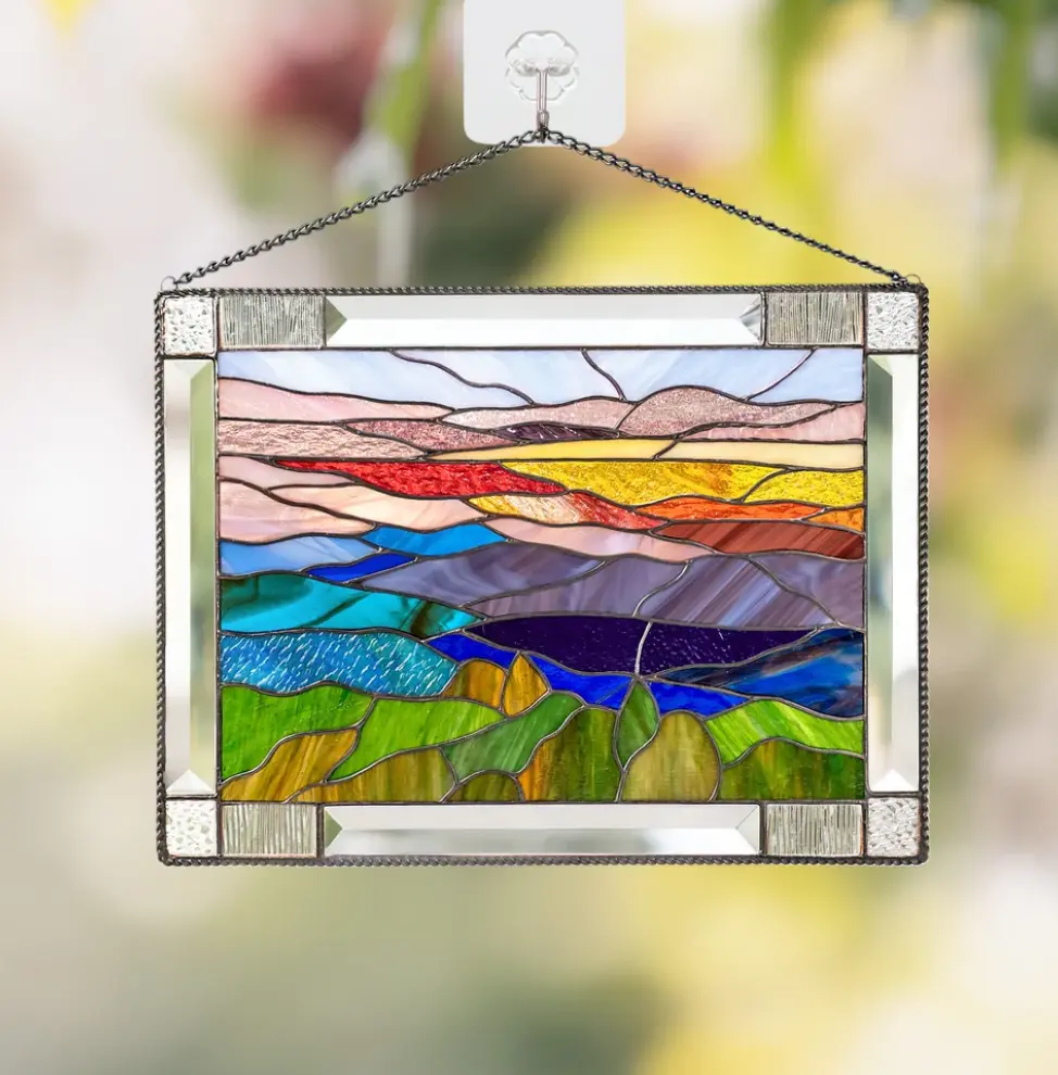 Handmade stained glass window filtering colorful natural light into a modern home throughout the day.